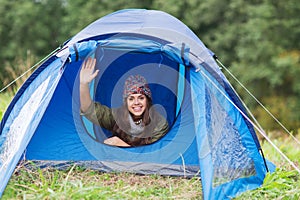 Smiling female tourist in tent