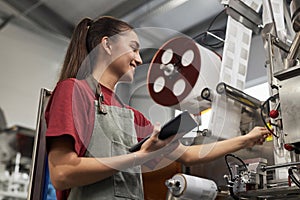 Smiling Female Worker Controlling Production Line of Drip Coffee Bags