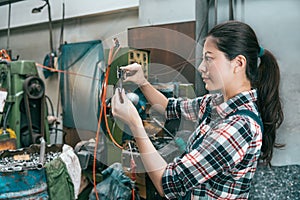 Smiling female worker staff using caliper scale