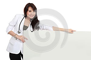 Smiling female young doctor holding blank white board