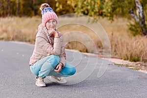 Smiling fifty-year-old woman in a hat in the autumn