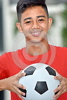 Smiling Filipino Male Soccer Player With Soccer Ball