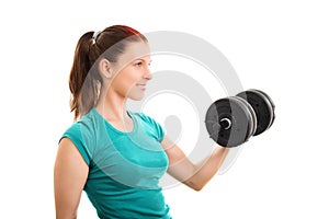 Smiling fit girl lifting a dumbbell