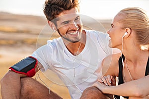 Smiling fitness couple relaxing together after jogging