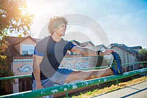 Smiling fitness man doing stretching exercise, preparing for workout .