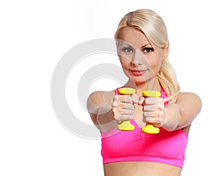 Smiling fitness woman lifting dumbbells. blonde young woman lifting weights, isolated