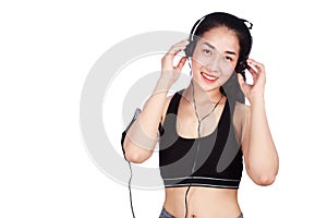 Smiling fitness woman listening to music with earphones isolated