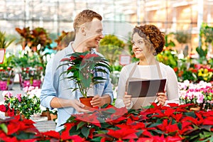 Smiling florist working with customer