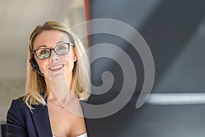 Smiling friendly confident businesswoman wearing a headset