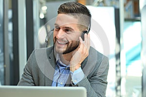 Smiling friendly handsome young male call centre operator