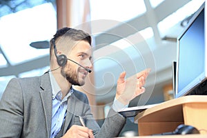 Smiling friendly handsome young male call centre operator