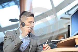 Smiling friendly handsome young male call centre operator