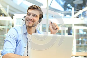 Smiling friendly handsome young male call centre operator