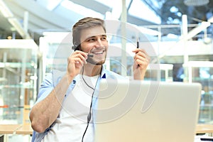 Smiling friendly handsome young male call centre operator