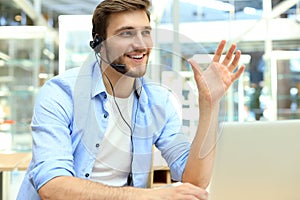 Smiling friendly handsome young male call centre operator