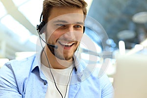 Smiling friendly handsome young male call centre operator