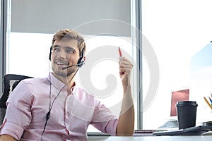 Smiling friendly handsome young male call centre operator
