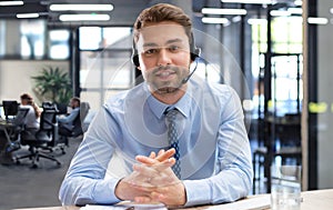 Smiling friendly handsome young male call centre operator