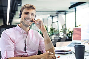 Smiling friendly handsome young male call centre operator