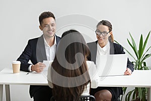 Smiling friendly hr managers interviewing female applicant, good