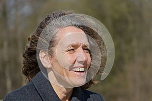 Smiling friendly woman with tousled hair