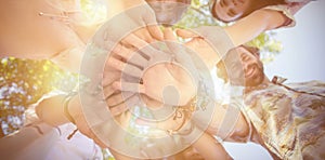 Friends forming a handstack in park