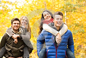 Smiling friends having fun in autumn park