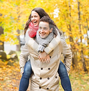 Smiling friends having fun in autumn park