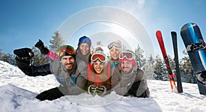 Smiling friends having fun on ski holiday in mountains