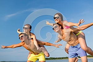 Smiling friends having fun on summer beach