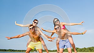 Smiling friends having fun on summer beach