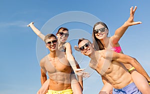 Smiling friends having fun on summer beach