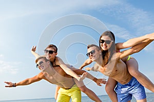 Smiling friends having fun on summer beach