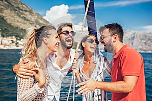 Smiling friends sailing on yacht.