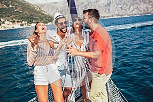 Smiling friends sailing on yacht.