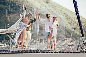 Smiling friends sailing on yacht.