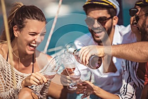 Smiling friends sailing on yacht.