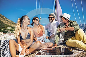 Smiling friends sailing on yacht.