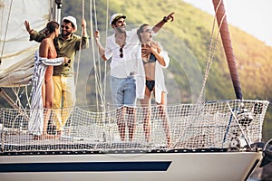 Smiling friends sailing on yacht.