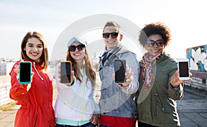 Smiling friends showing blank smartphone screens