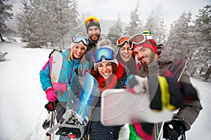 Smiling friends with ski on winter holidays - Skiers having fun