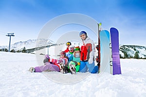 Smiling friends with snowboards in the mountains