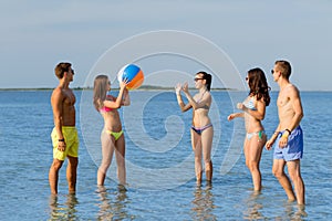 Smiling friends in sunglasses on summer beach