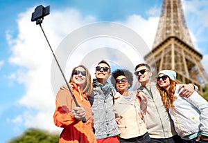 Smiling friends taking selfie with smartphone