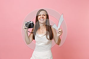 Smiling funny bride woman in wedding dress holding retro vintage photo camera and check mark, choosing staff