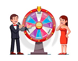 Game show host man showing wheel of fortune photo