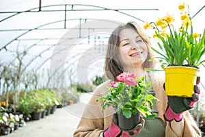 Smiling Gardener Presenting Potted Flowers