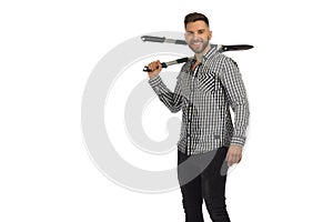 Smiling gardener is standing with big secateur on his shoulder. Studio shot isolated on white