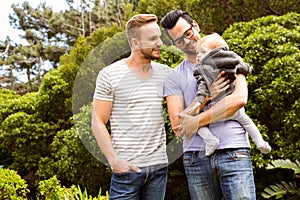 Smiling gay couple with child