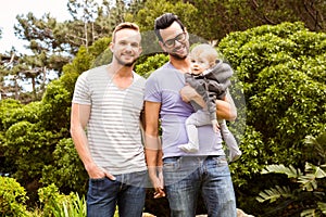 Smiling gay couple with child